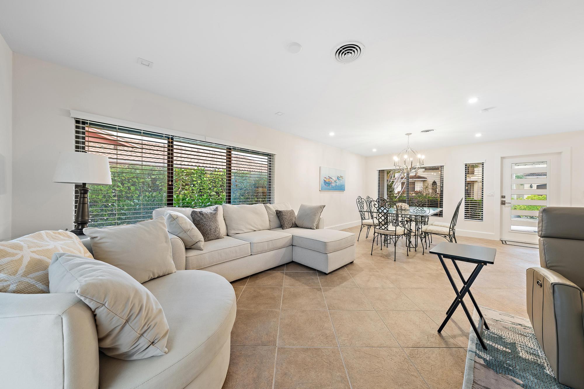 1120 Singer Drive Riviera Beach, FL 33404 - Photo 9 of 37 a living room with furniture and a large window