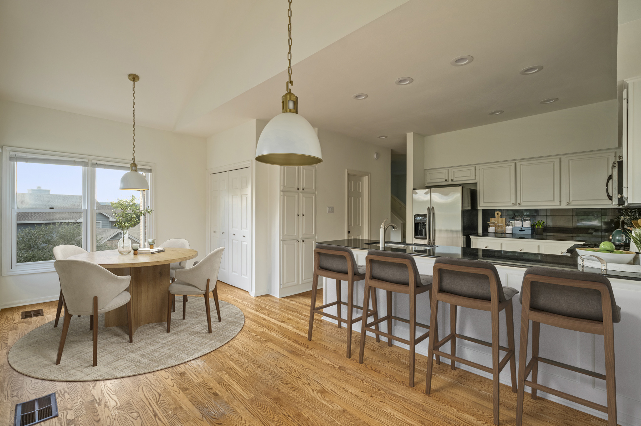 6010 Long Champ Court, Unit 113 Austin, TX 78746 - Photo 5 of 25 Virtually staged. Kitchen with a kitchen bar, backsplash, a peninsula, light wood finished floors, and stainless steel appliances