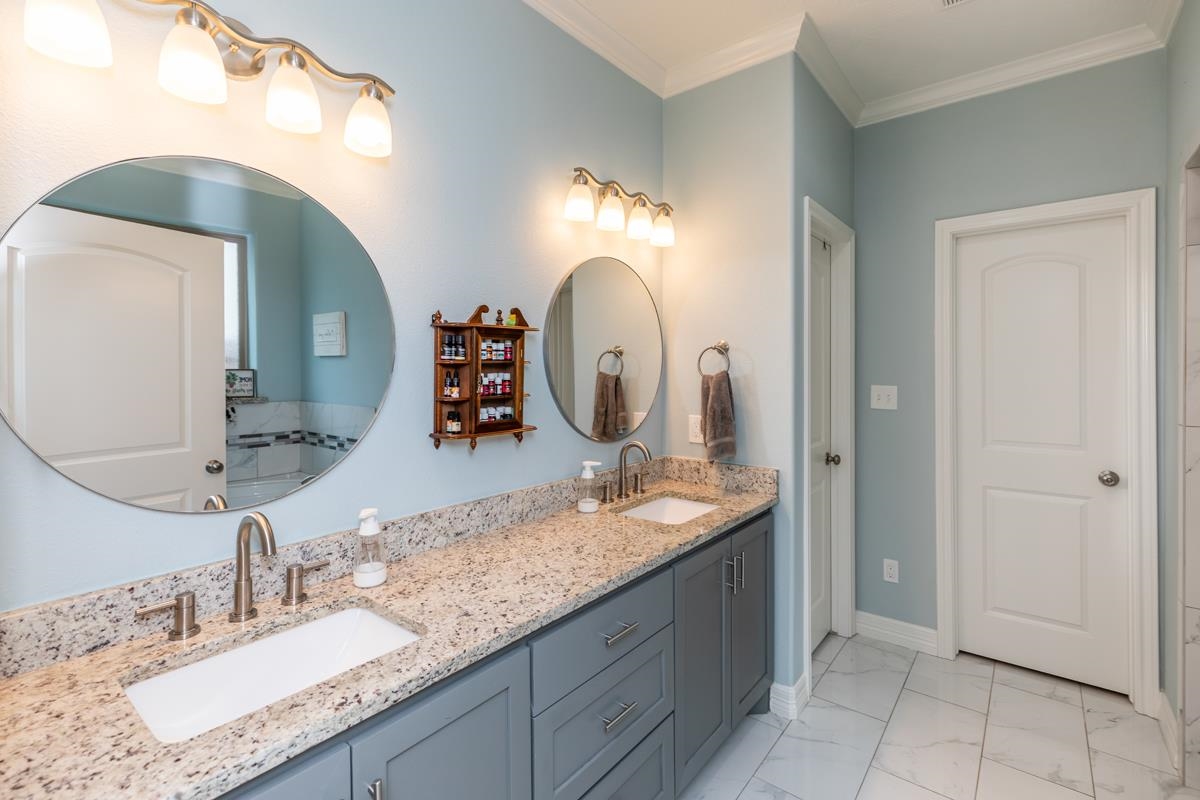 314 Long Leaf Street Silsbee, TX 77656 - Photo 16 of 31 a bathroom with a granite countertop double vanity sink and a mirror