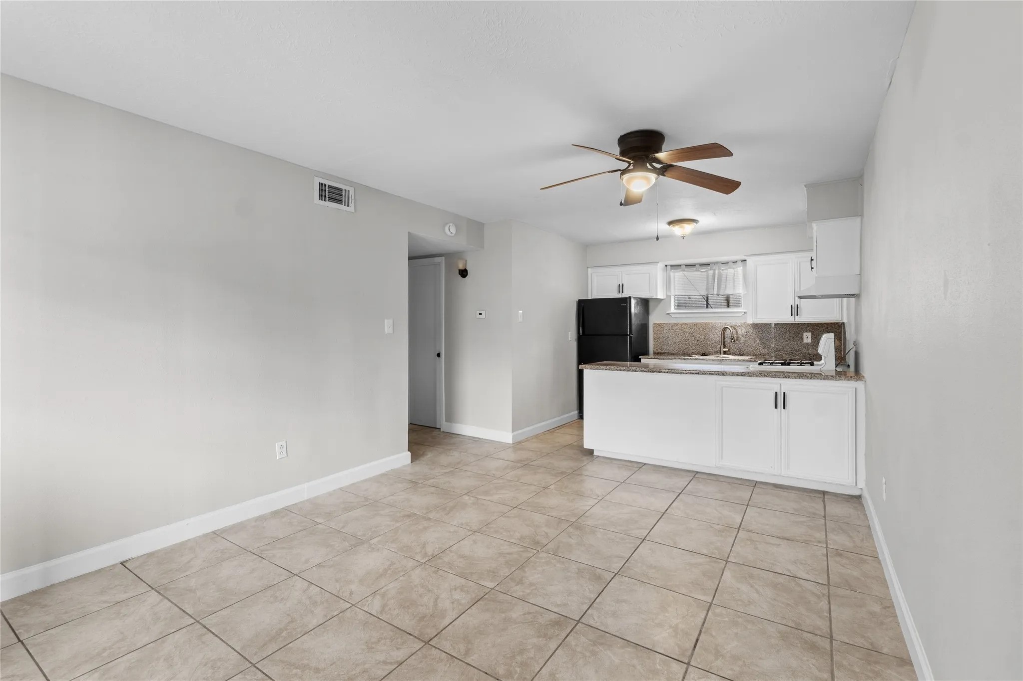 a view of a kitchen with electric appliances