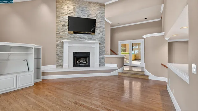 an empty room with wooden floor and a window