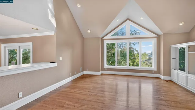 a view of a kitchen with wooden floor and a kitchen