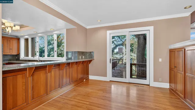 a kitchen with stainless steel appliances granite countertop wooden floors and sink