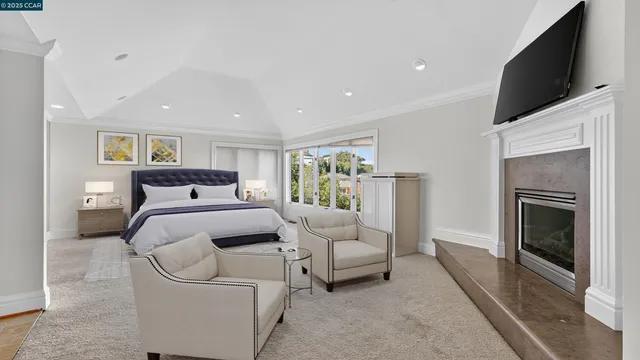 a view of a livingroom with furniture fire place and a refrigerator