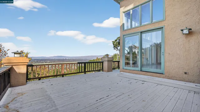 an aerial view of residential house with outdoor space and trees all around