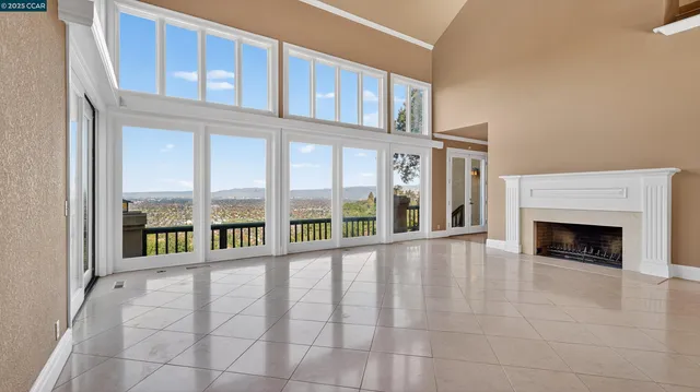 a view of an entryway with a floor to ceiling window and a kitchen