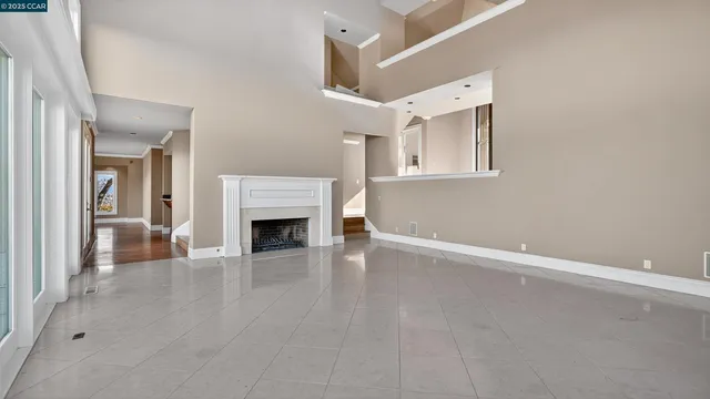 a view of a livingroom with a fireplace and window