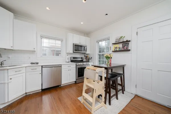 a kitchen with a sink cabinets and wooden floor