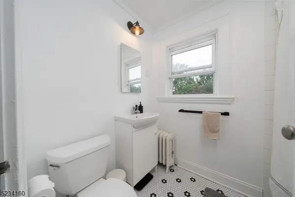 a white toilet sitting next to a bathroom sink