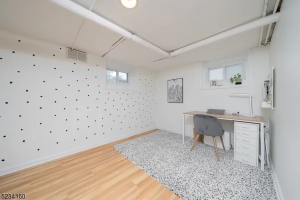 a bathroom with a tub sink shower and mirror