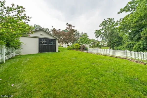a house view with a play ground in front of it