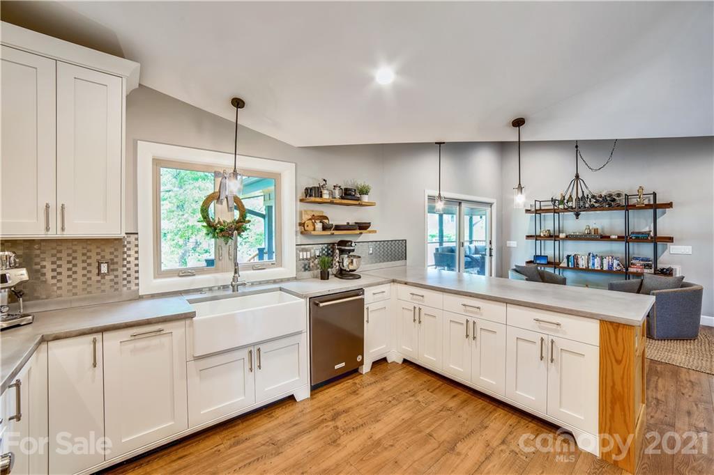 5016 Kiser Island Road Terrell, NC 28682 - Photo 18 of 37 a kitchen with kitchen island granite countertop white cabinets and white appliances