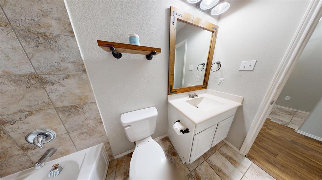 3101 Buckthorn Street Forney, TX 75126 - Photo 23 of 40 Bathroom featuring a single vanity with storage, a rectangular sink, and a wood-framed mirror