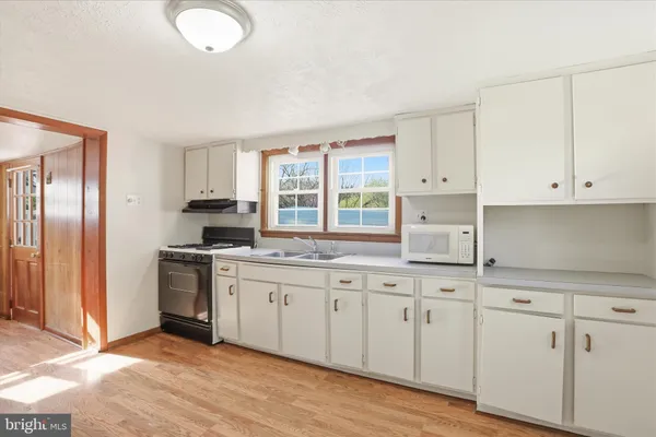 a kitchen with a stove and a sink
