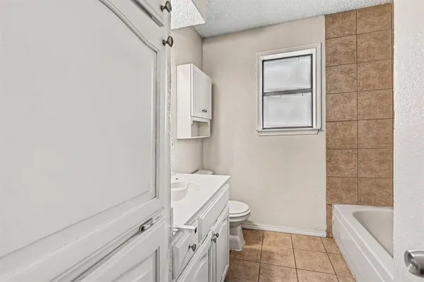 a bathroom with a toilet a sink and bathtub