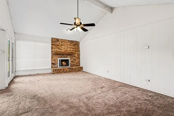 a view of empty room with furniture and ceiling fan