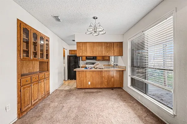 a view of kitchen with stainless steel appliances cabinets