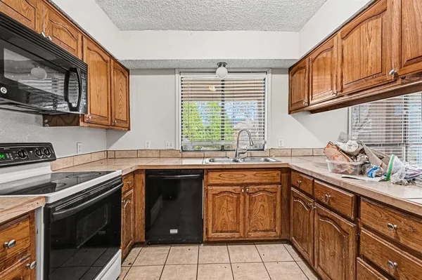 a kitchen with a sink stove top oven and cabinets