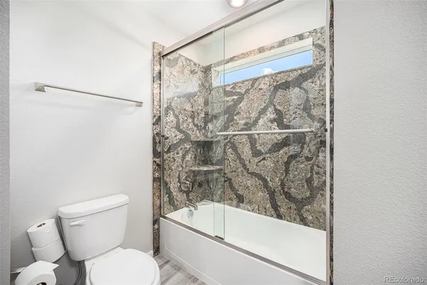 a bathroom with a toilet and a shower