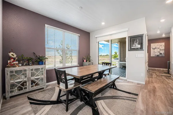 a dining room with furniture and wooden floor
