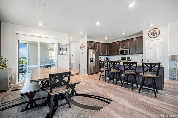 a dining room with furniture and wooden floor
