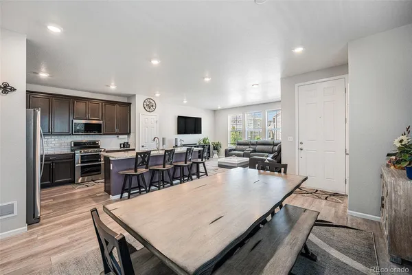 a large kitchen with lots of counter space a sink appliances and a dining table