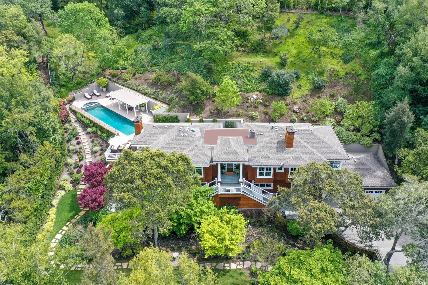 an aerial view of a house with swimming pool and outdoor space