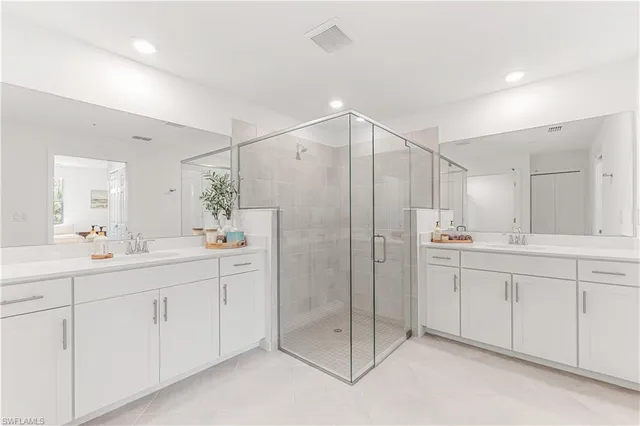 a bathroom with a shower sink and mirror