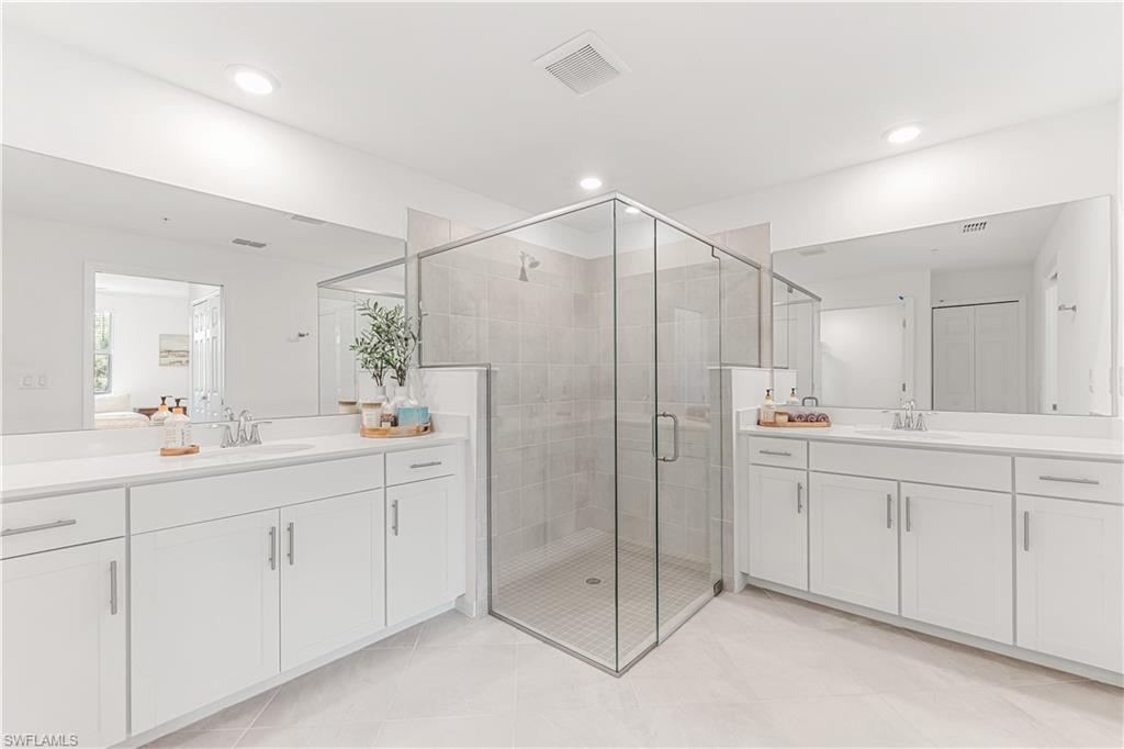 43333 Water Bird Way, Unit 4812 Babcock Ranch, FL 33982 - Photo 12 of 19 a bathroom with a shower sink and mirror