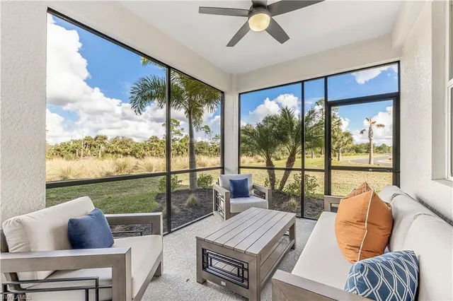 a living room with furniture and a floor to ceiling window