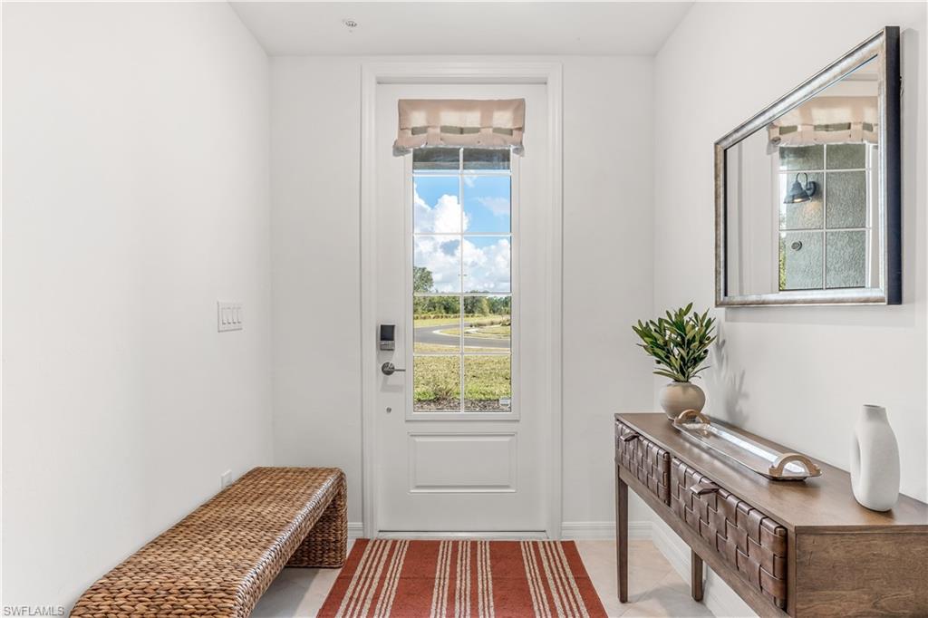 43333 Water Bird Way, Unit 4812 Babcock Ranch, FL 33982 - Photo 3 of 19 a view of a bedroom with wooden floor and small window