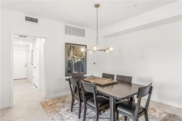 a view of a dining room with a table and chairs