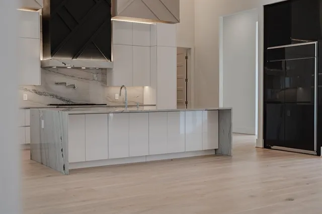 a kitchen with cabinets and window