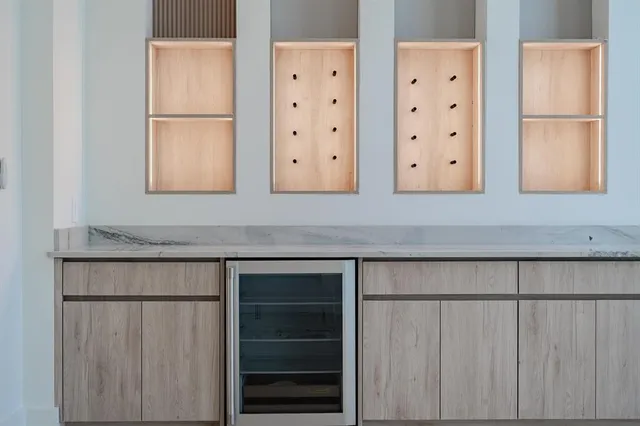 a kitchen with cabinets and a refrigerator