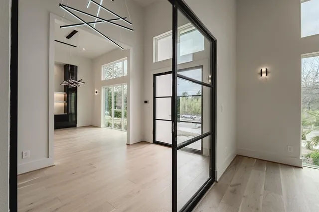 a view of a hallway with wooden floor and entryway