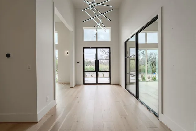 a view of a room with wooden floor and windows