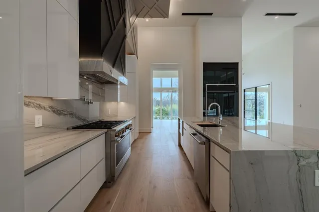 a kitchen with granite countertop a stove and a sink