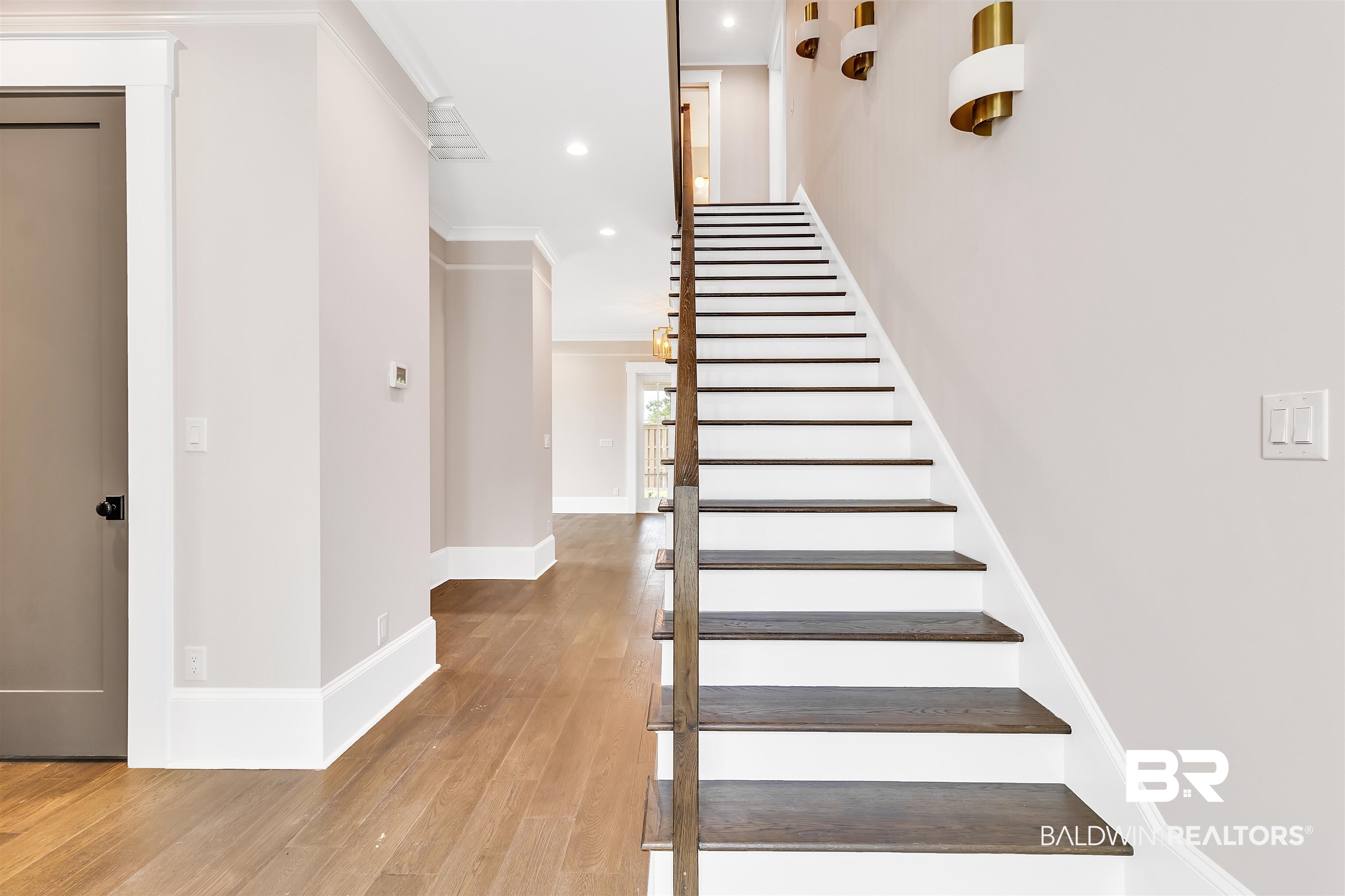 829 Inlet Circle Gulf Shores, AL 36542 - Photo 12 of 31 Staircase with wood-type flooring and crown molding