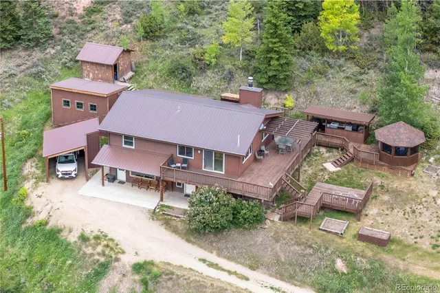an aerial view of a house with a yard
