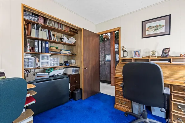 a view of a workspace with furniture and wooden floor