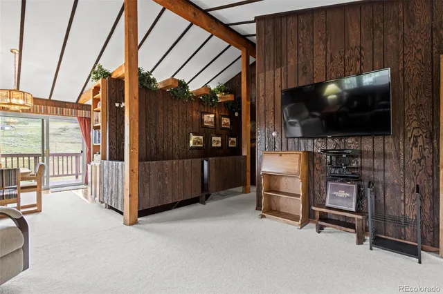 a living room with furniture a flat screen tv and a lamp