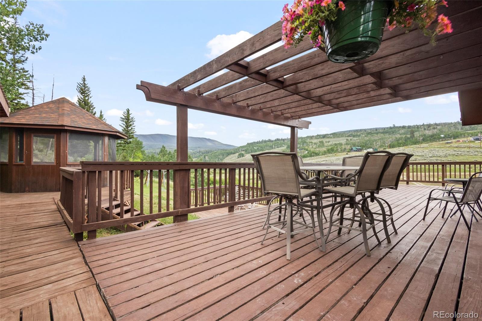 360 Gcr 194 Kremmling, CO 80459 - Photo 39 of 50 a view of a roof deck with table and chairs a barbeque with wooden floor and fence