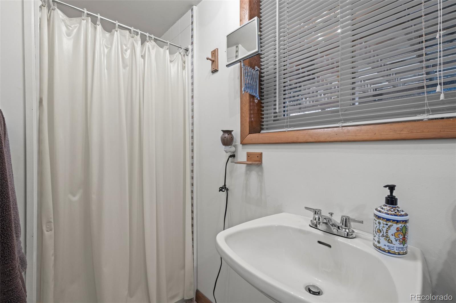 360 Gcr 194 Kremmling, CO 80459 - Photo 44 of 50 a bathroom with a sink a shower curtain and a sink