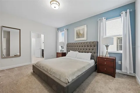 a bedroom with a bed and a night stand