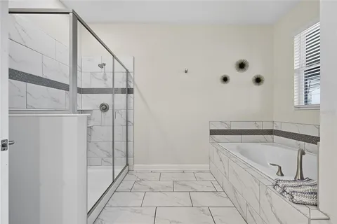 a bathroom with a bathtub and shower