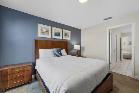 a bedroom with a bed and a dresser