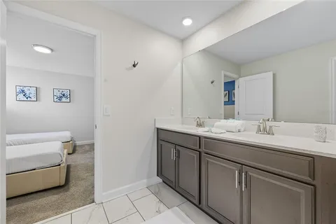 a bathroom with a double vanity sink mirror and toilet