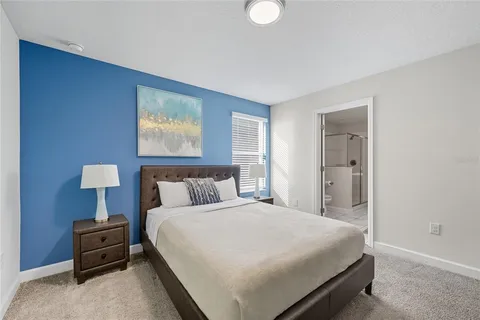 a bedroom with bed and a night stand