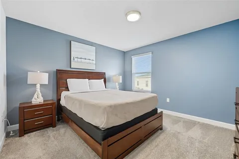 a bedroom with a bed and a lamp