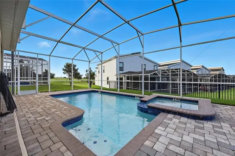a view of a swimming pool with a lounge chair